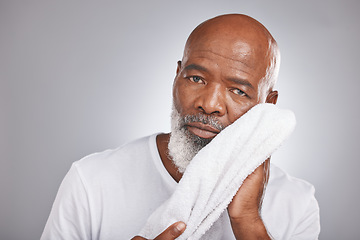 Image showing Portrait, towel or old man cleaning face in studio with marketing or mock up space for skincare beauty. Wellness, glowing skin or healthy senior black man grooming with facial cosmetics or product