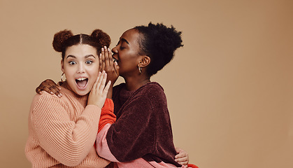 Image showing Friends, gossip and women share secret on studio background and product placement mockup. Secrets, rumours and surprise whisper in ear, black woman with happy woman discuss discount sale announcement