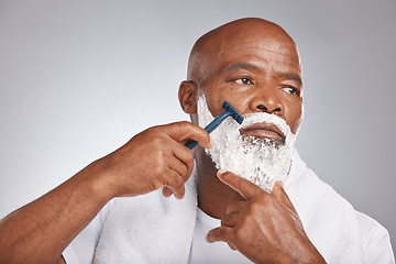 Image showing Face, shaving cream and black man with razor on beard, skincare spa treatment on grey background. Health, mock up and facial hair, mature man morning shave routine with space for product placement.