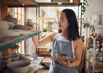 Image showing Pottery, woman or small business owner with inventory, stock and product quality, management and production results. Art startup checklist, creative worker and asian designer check design on a shelf