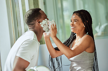 Image showing Shave, playing and funny with a black couple laughing or joking together in the bathroom of their home. Love, shaving and laughter with a man and woman having fun while bonding in the morning