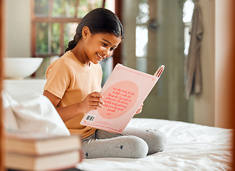 Image showing Child or girl reading for home learning, story and language education with creative development o bed. Happy, kindergarten Indian kid with English books for smart, intelligent and fun house activity