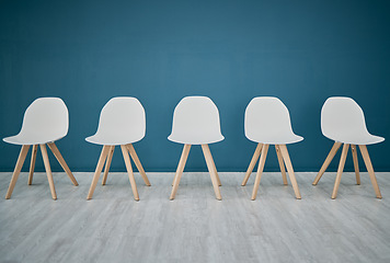 Image showing Chairs, line and waiting room in the office corridor for an interview, meeting or recruitment. Seats, row and empty stools in the hallway or boardroom of the modern business workplace for hiring.