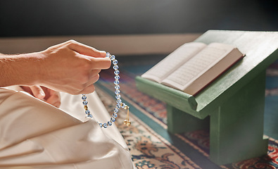 Image showing Quran, beads or hands praying in Islamic or Muslim religion to Allah for spiritual peace or freedom in mosque in Qatar. Muslim pray, reading or person kneeling on carpet in holy temple to praise God