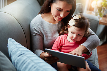 Image showing Family, baby and tablet with a mother and daughter sitting on a sofa in the living room of their home for development. Kids, education or overhead with a woman and girl child learning in a house