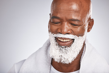 Image showing Face, shaving cream and happy black man with smile on beard, skincare treatment on grey background. Health, mock up and facial hair, mature man morning shave routine with space for product placement.