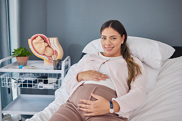 Image showing Pregnant woman, doctor consultation office and portrait of a new mother ready for ultrasound. Hospital bed, medical clinic and mama smile with happiness hold her stomach at a healthcare consultation