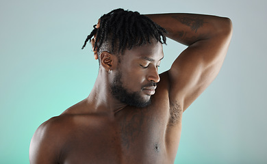 Image showing Armpit, wellness and black man with skincare hygiene or grooming isolated against a studio background. Natural, cosmetics and body care for healthy skin by a young, confident and African model