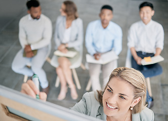 Image showing Presentation, training and woman writing on board in a meeting for planning, coaching and strategy. Happy, executive and face of a manager teaching employees, giving help and leadership in a workshop