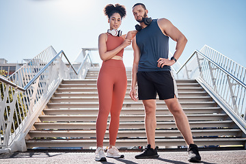 Image showing Couple, city stairs and portrait for fitness with headphones, music and motivation for urban workout together. Exercise team, black couple and support for health, wellness and training in Cape Town