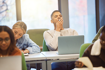 Image showing Education, man and student tired, classroom and studying for exams, laptop and learning. Male, academic and exhausted for test, overworked and fatigue with research work, college stress and burnout