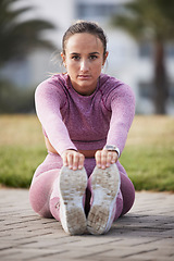 Image showing Woman, exercise and fitness portrait while stretching outdoor at a city park for health and wellness. Athlete female sitting for warm up, cardio workout and running for healthy lifestyle and body