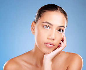 Image showing Face portrait, beauty skincare and woman in studio isolated on a blue background. Makeup, cosmetics and young female model with healthy, glowing and flawless skin after luxury spa facial treatment.