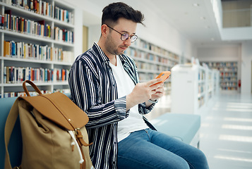 Image showing Library, university and man with phone on sofa for education, research and checking social media. Networking, knowledge and male student on smartphone, mobile app and website in college bookstore