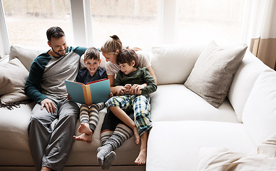 Image showing Happy, learning and parents reading a book with children for bonding, fun and quality time. Knowledge, information and boys excited about a story on the lounge sofa with their mother and father