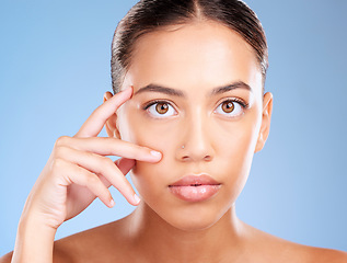 Image showing Face portrait, beauty skincare and woman in studio isolated on a blue background. Makeup, cosmetics and young female model with healthy, glowing and flawless skin after luxury spa facial treatment.