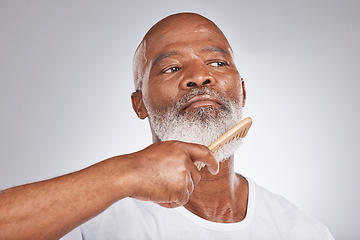 Image showing Elderly, black man with comb for beard, beauty and grooming with hygiene and cosmetic care against studio background. Hair care mockup, brush body hair and face with hair treatment and cosmetics