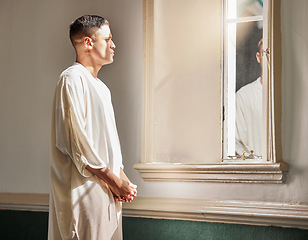 Image showing Prayer, reflection and muslim man in mosque with mirror in Saudi Arabia, meditation and spiritual wellness in worship. Religion, hope and culture, islamic student thinking or praying during Ramadan.