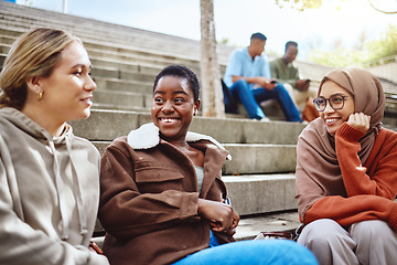 Image showing Happy women, diversity or talking on university stairs, school steps or college campus in bonding class break. Smile, black woman or muslim students laughing in relax education group or learning rest