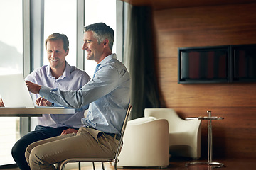 Image showing Business, men and laptop with connection, typing and digital marketing with happiness, conversation and modern office. Male employees, manager and leader with employee, coworkers and online reading