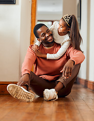 Image showing Family, father and daughter hug in their home, happy and relax while bonding and having fun. Love, black man and girl with parent, smile and embrace, content and sitting on a floor together