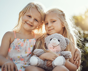 Image showing Children, smile and teddy outdoor portrait with happiness, smile and bonding together. Freedom, happiness and smiling of a young girl with friend love and care in a park or garden feeling free