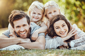 Image showing Family, park and outdoor portrait of parents and girl children with love and care in nature. Mother, dad and kids with a smile in summer feeling happy on green grass bonding together on a picnic