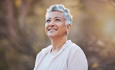 Image showing Senior woman, nature and thinking while outdoor for freedom, happiness and a healthy lifestyle with fitness and fresh air. Face of happy black female at park for peace, health and wellness in summer