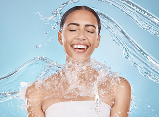 Image showing Happy woman, face or water splash skincare on blue background studio in healthcare wellness, Brazil hygiene cleaning or relax grooming. Beauty model, wet or water drops shower for facial dermatology