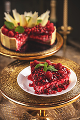 Image showing Cheesecake with red berries sauce