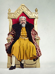 Image showing King, royalty and angry man on throne in studio isolated on a gray background mockup.Thinking, medieval and annoyed senior male, upset leader or frustrated ruler with crown sitting on golden seat.