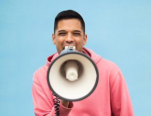 Image showing Portrait, protest and megaphone with a man in studio on a blue background for an announcement or speech. Freedom, human rights and loudspeaker with a male at a rally for equality or revolution