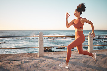 Image showing Sprinting, running and woman training by the beach for fitness, cardio and exercise in Thailand. Commitment, sports and latino runner on the promenade for a workout, start of a race or marathon