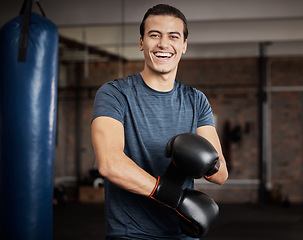 Image showing Fitness, portrait and man with boxing gloves in gym for training, exercise or training. Happy, smile and male athlete or boxer doing cardio kickboxing workout for health or wellness in sports studio.