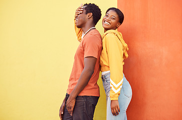 Image showing Fashion portrait, people or couple of African friends relax with designer brand clothes, casual style and luxury apparel. Urban gen z aesthetic, black woman and man on orange yellow background wall