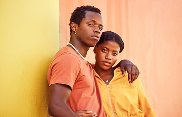 Image showing Fashion portrait, people or couple of African friends relax with designer brand clothes, casual style and luxury apparel. Urban gen z aesthetic, black woman and man on orange yellow background wall