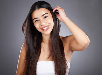 Image showing Hair care woman, smile and studio portrait for healthy cosmetic treatment, style and happy by backdrop. Model, hair health and natural shine with beauty, wellness and makeup glow by studio background