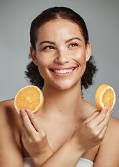 Image showing Model, orange and hands in studio for skincare, health and wellness for cosmetic glow, self care and backdrop. Black woman, fruit aesthetic and diet for cosmetics, detox or natural skin by background