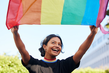 Image showing Rainbow, flag and lgbt with an indian woman in the city in celebration of human rights, equality or freedom. Community, support and gay with a gender neutral or non binary female celebrating lgbtq