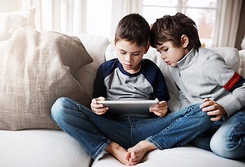 Image showing Sibling boys, tablet and couch for games, relax and digital app for learning, web streaming or movie. Kids, sofa and mobile tech on social media, education or video for development, reading or gaming