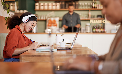 Image showing Woman, student and studying in cafe, laptop and make notes for exams, smile and concentration for test. Young female, lady or academic with headphones, podcast or writing audio to text in coffee shop