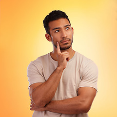 Image showing Thinking, wondering and thoughtful Asian man with a choice isolated on a yellow background in a studio. Curious, think and Japanese person with a problem, thoughts or idea on a bright backdrop