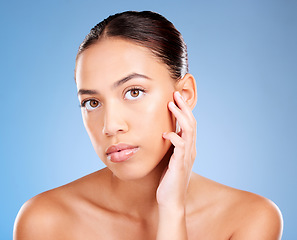 Image showing Portrait, skincare and woman with natural beauty, cosmetics and on blue studio background. Face, female and girl with makeup, treatment for glow and luxury routine for smooth, clear and soft skin.