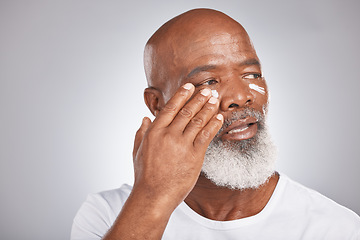 Image showing Skincare, beauty or old man with facial cream marketing or advertising luxury beauty product for self care. Studio background, mockup space or senior black mans hand applying facial mask or cosmetics