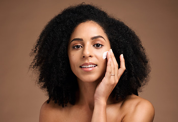 Image showing Face, cream and black woman in studio for skincare, beauty and cosmetics promotion with product application in portrait. African model with skin care, dermatology and sunscreen wellness in a headshot