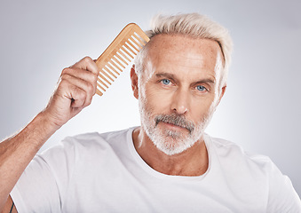 Image showing Mature man, portrait and hair comb on studio background from barbershop, salon skincare and healthy cosmetics. Face, male model and brushing hair care for fashion, shampoo product and morning routine