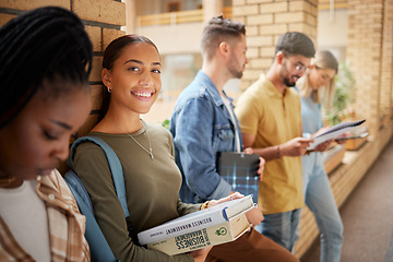 Image showing University, hallway and portrait of woman and students standing in row together with books at business school. Friends, education and future, happy woman in study group on campus in lobby for exam.