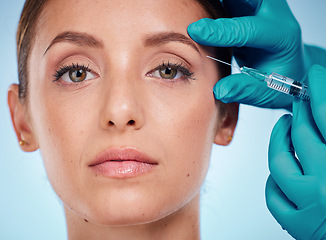 Image showing Plastic surgery, skincare and woman with injection, healthcare and on blue studio background. Female, girl and botox with cosmetics, wellness and face care for health, soft and smooth skin for beauty