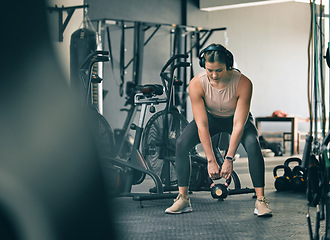 Image showing Kettlebell weight, fitness gym woman with workout, training and exercise with headphones. Sport focus, wellness and healthy athlete busy with muscle and cardio development in a health studio