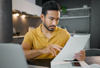 Image showing Businessman, home office and documents by laptop in kitchen for focus, small business growth and opportunity. Digital entrepreneur, business owner and reading with contract, proposal and paperwork